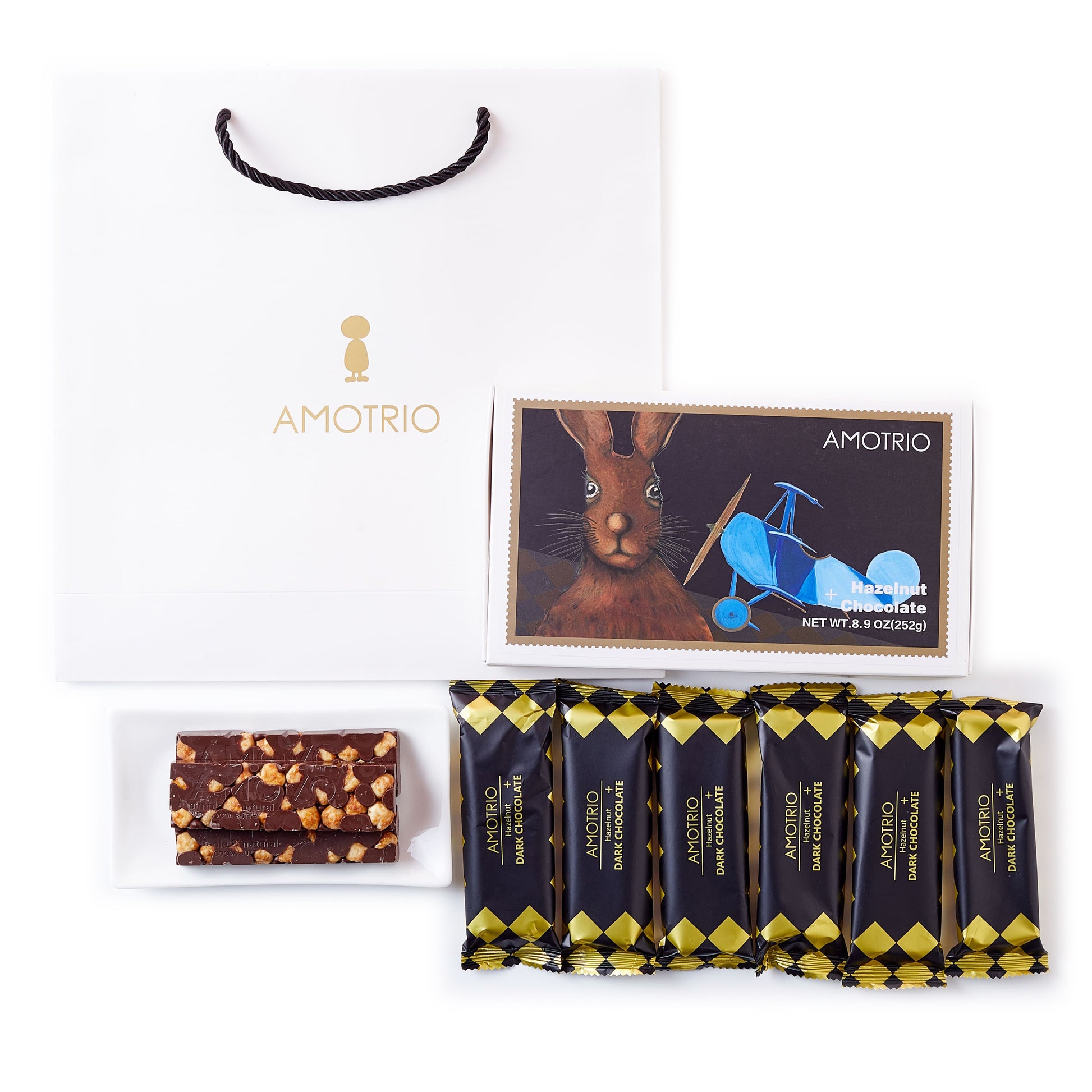 Packaging and contents of Amotrio Whole Hazelnut Dark Chocolate Bars