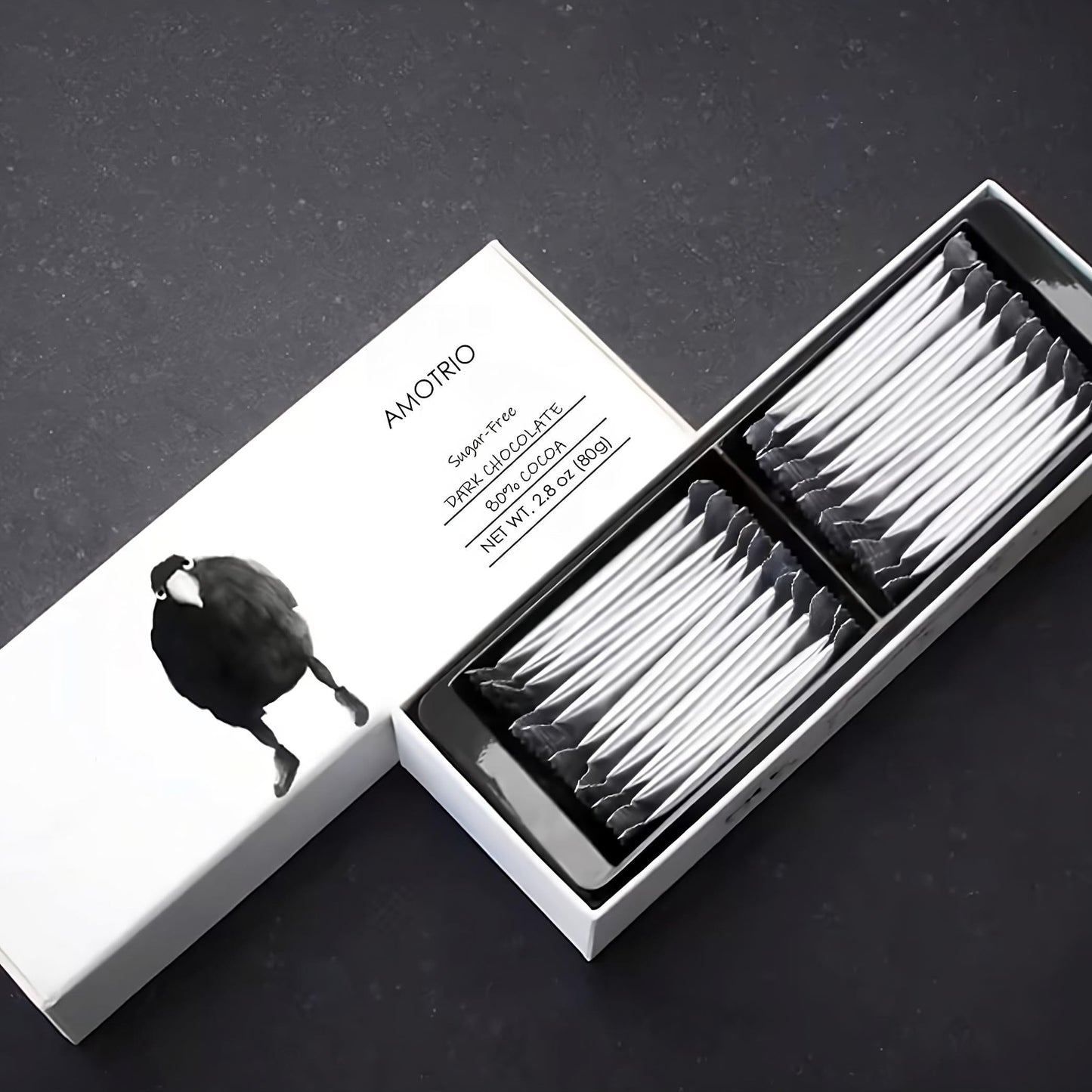 Illustrated packaging of Amotrio sugar-free dark chocolate bar with cute raven design