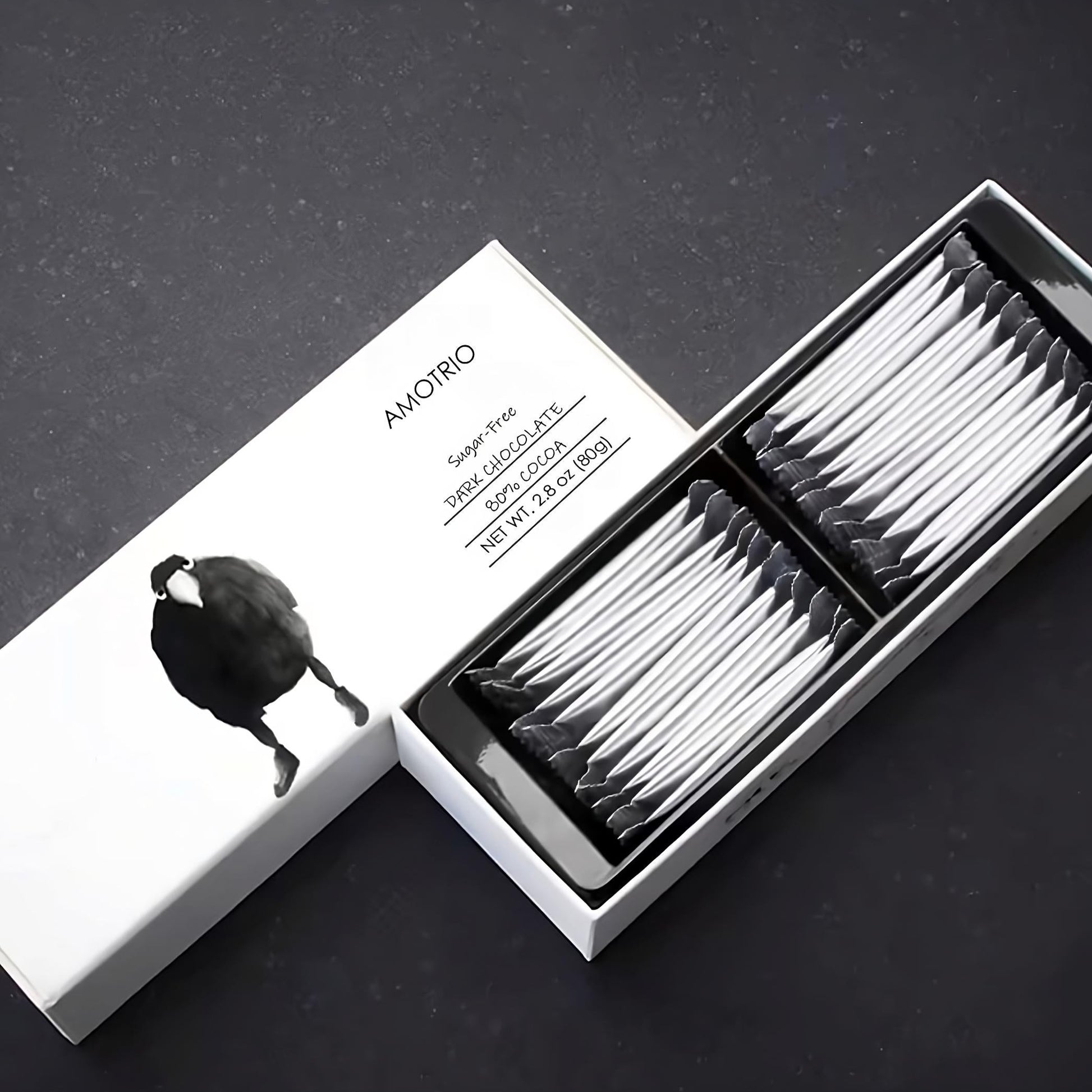 Illustrated packaging of Amotrio sugar-free dark chocolate bar with cute raven design