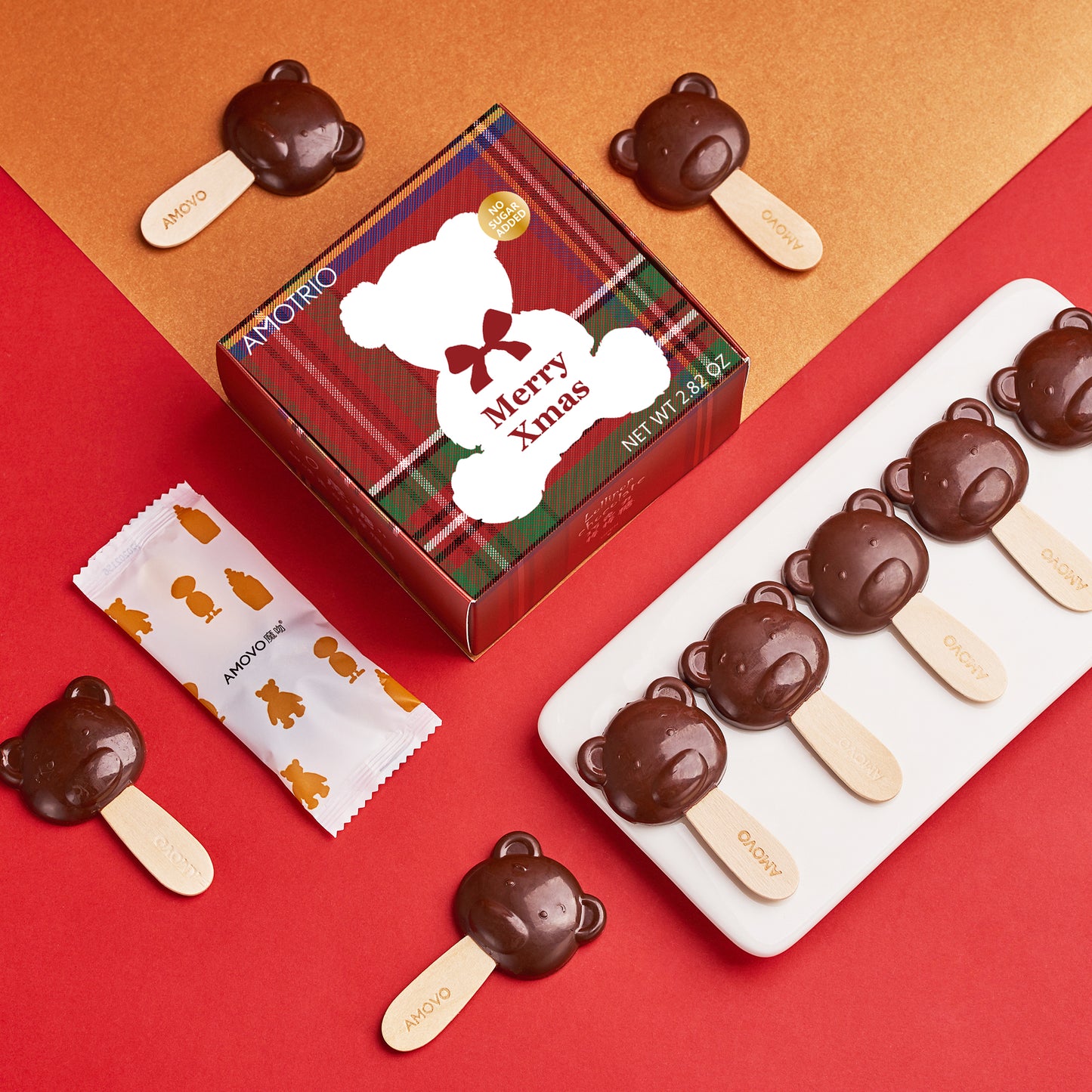 Photo of a bear shape dark chocolate lollipop with the packaging alongside 